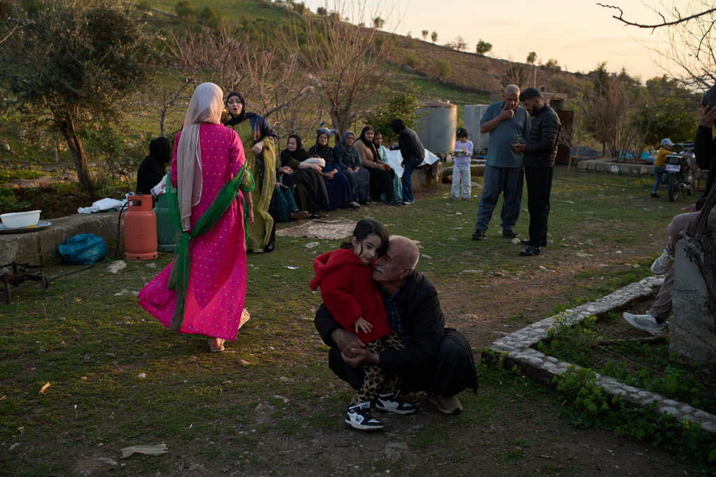 People take part in a family gathering to break the fast with an Iftar meal during the Muslim holy month of Ramadan in the village of Gulp, Iraq, Tuesday, March 17, 2026. (AP Photo/Leo Correa)