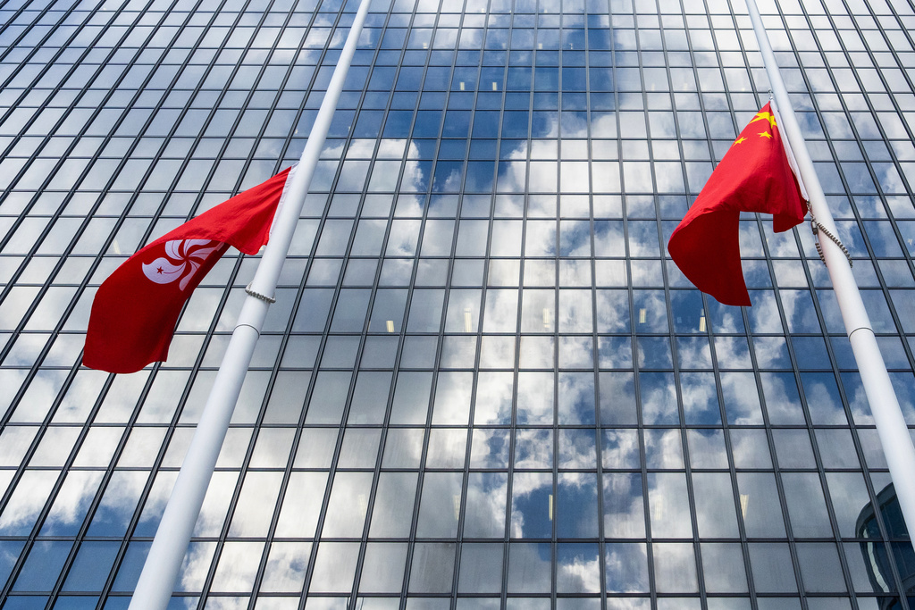 Chinese and Hong Kong Special Administrative Region flags fly at half-mast to mourn the victims of the deadly fire that started Wednesday at Wang Fuk Court, a residential estate in the Tai Po district of Hong Kong's New Territories, Saturday Nov. 29, 2025. (AP Photo/Chan Long Hei)