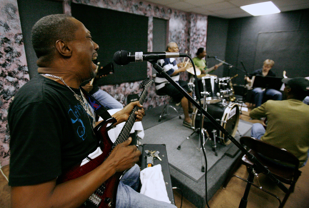 FILE - Andre "Dadou" Pasquet, left, sings and plays guitar with the Magnum compas band during a practice session in North Miami, Fla. Thursday, May 8, 2008. (AP Photo/Lynne Sladky, File)