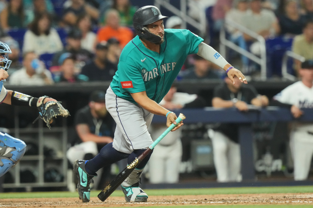 Seattle Mariners' Josh Naylor hits a single during the eighth inning of a baseball game against the Miami Marlins Tuesday, July 7, 2026, in Miami. (AP Photo/Marta Lavandier)