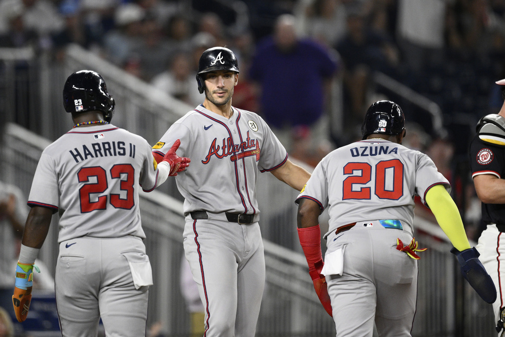 Atlanta Braves' Matt Olson, center, celebrates after his three-run home run with Marcell Ozuna (20) and Michael Harris II (23) during the fifth inning of a baseball game against the Washington Nationals, Monday, Sept. 15, 2025, in Washington. (AP Photo/Nick Wass)