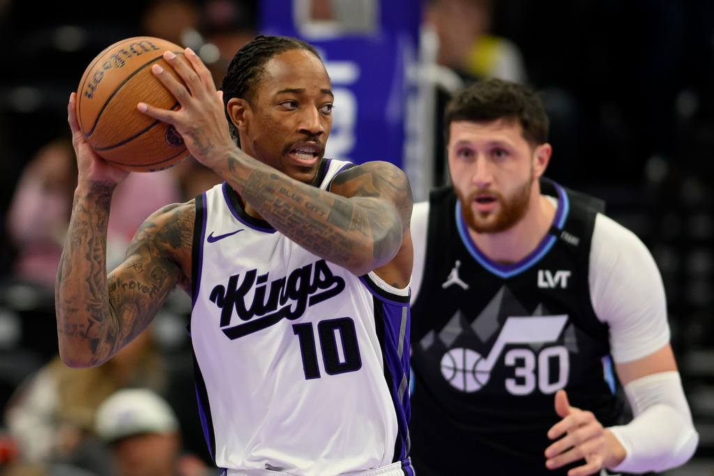 Sacramento Kings guard DeMar DeRozan (10) posts up guarded by Utah Jazz center Jusuf Nurkic (30) during the first half of an NBA Cup basketball game, Friday, Nov. 28, 2025, in Salt Lake City. (AP Photo/Tyler Tate)
