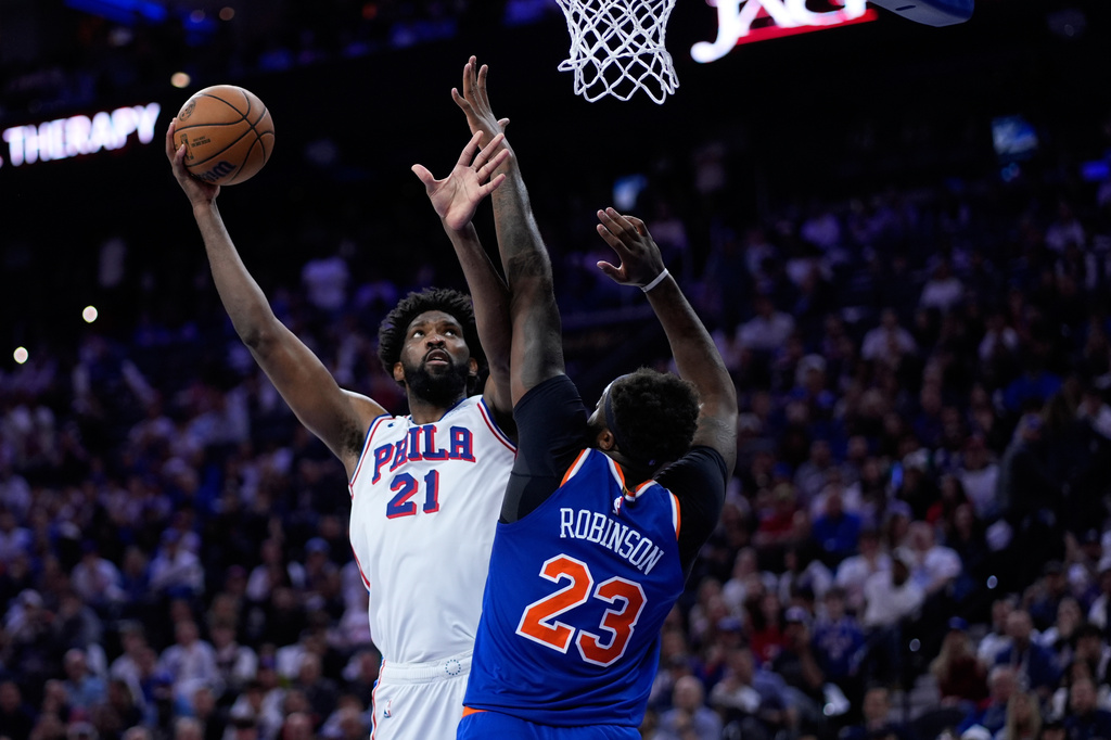 Philadelphia 76ers' Joel Embiid, left, goes up for a shot against New York Knicks' Mitchell Robinson during the second half of Game 3 in a second-round NBA basketball playoff series Friday, May 8, 2026, in Philadelphia. (AP Photo/Matt Slocum)