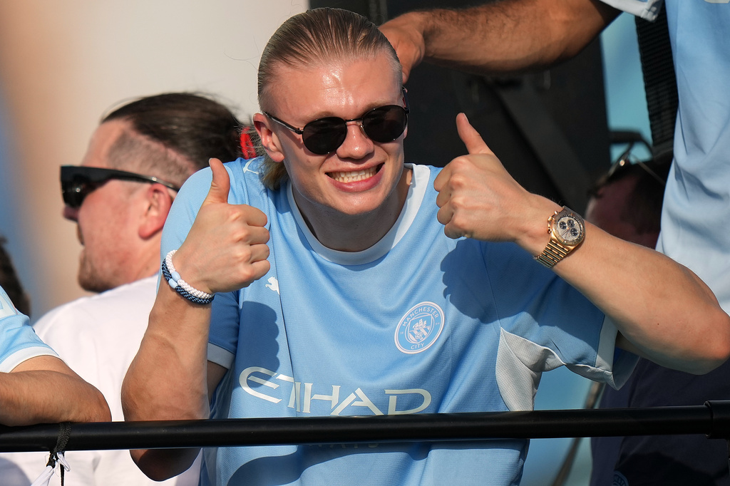 Manchester City's Erling Haaland celebrates on an open top bus during a parade to celebrate the achievements of the Manchester City men's and women's teams this season in Manchester, Monday, May 25, 2026.(AP Photo/Alastair Grant)