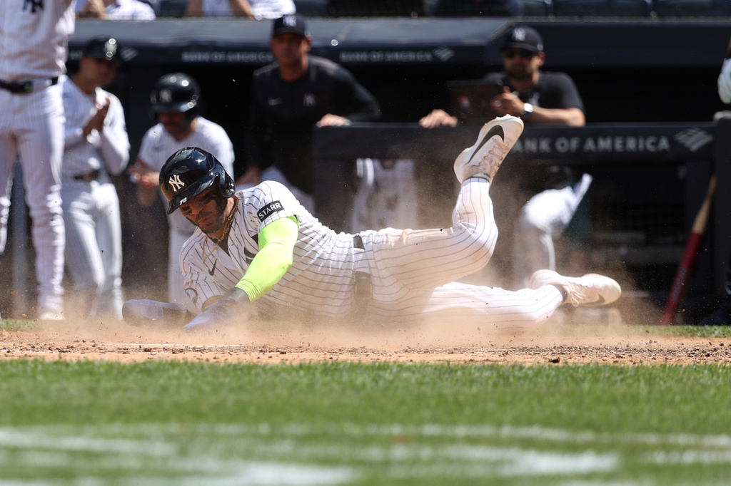 New York Yankees' José Caballero slides to score on a single hit by Paul Goldschmidt during the fifth inning of a baseball game against the Boston Red Sox, Sunday, June 7, 2026, in New York. (AP Photo/Pamela Smith)