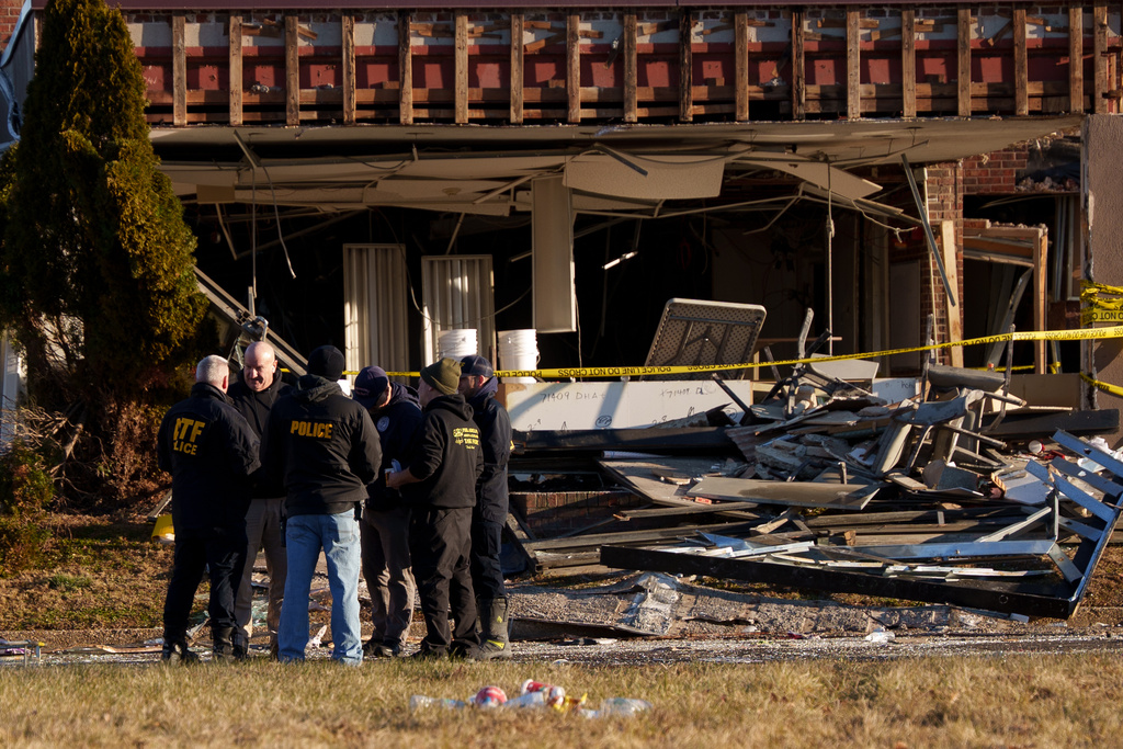 FILE - Investigators work around Bristol Health & Rehab Center and surrounding rubble after a gas explosion the day prior on Dec. 24, 2025, in Bristol, Pa. (AP Photo/Mingson Lau, File)