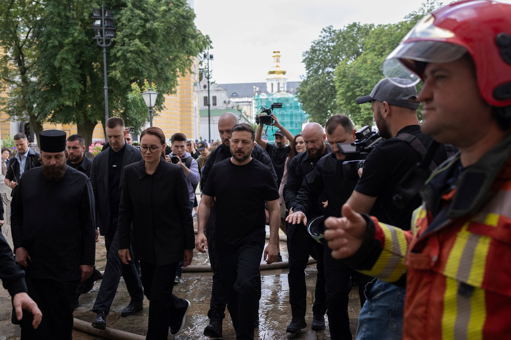Accompanied by Ukrainian Prime Minister Yulia Svyrydenko, center left, President Volodymyr Zelenskyy, center, inspects the damage caused by a Russian drone strike at the Dormition Cathedral of the Kyiv-Pechersk Lavra in Kyiv, Ukraine, Monday, June 15, 2026. (Ukrainian Presidential Press Office via AP)