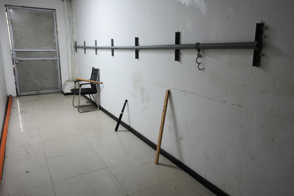 A baton, stick and handcuffs are seen in the "torture room" where workers were allegedly tied to steel rods and punished if they did not perform as expected at a former scam compound that is now being used as the Presidential Anti-Organized Crime Commission temporary detention center in Pasay, Philippines, Tuesday, Sept. 1, 2026. (AP Photo/Aaron Favila)