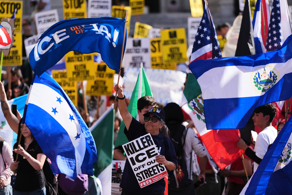 People gather during a protest on Friday, Jan. 30, 2026, in Los Angeles. (AP Photo/Jae C. Hong)