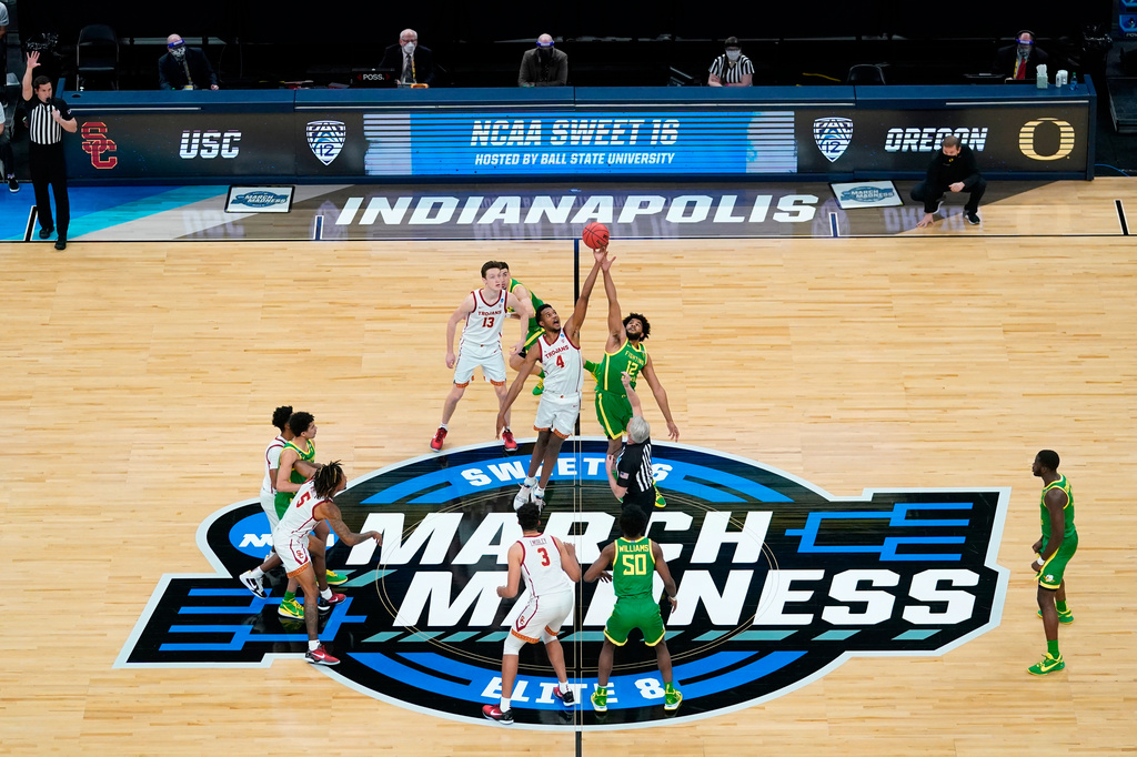 FILE - Southern California forward Evan Mobley (4) fights for the opening tipoff with Oregon guard LJ Figueroa (12) during the first half of a Sweet 16 game in the NCAA men's college basketball tournament, March 28, 2021, in Indianapolis. (AP Photo/Darron Cummings, File)