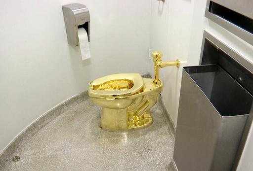FILE - This Sept. 16, 2016 file image made from a video shows the 18-karat toilet, titled "America," by Maurizio Cattelan in the restroom of the Solomon R. Guggenheim Museum in New York. (AP Photo, File) FILE - This Sept. 16, 2016 file image made from a video shows the 18-karat toilet, titled "America," by Maurizio Cattelan in the restroom of the Solomon R. Guggenheim Museum in New York. (AP Photo, File)