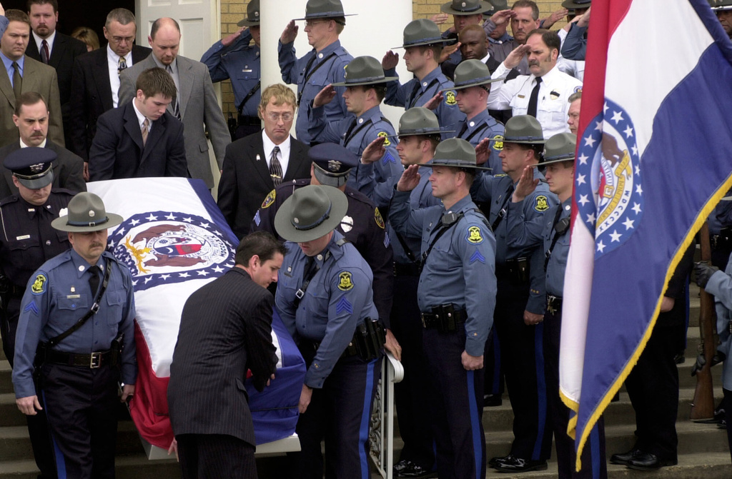 FILE - Members of the Missouri State Highway Patrol salute the body of fellow officer Sgt. Carl ''Dewayne'' Graham Jr., after funeral services March 24, 2005, in Dexter, Mo. (AP Photo/Bill Boyce, File)