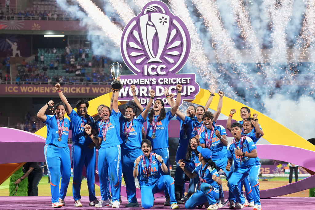 India's players pose with the winning trophy after their win over South Africa in the ICC Women's Cricket World Cup final match in Navi Mumbai, India, Monday, Nov. 3, 2025. (AP Photo/Rafiq Maqbool)