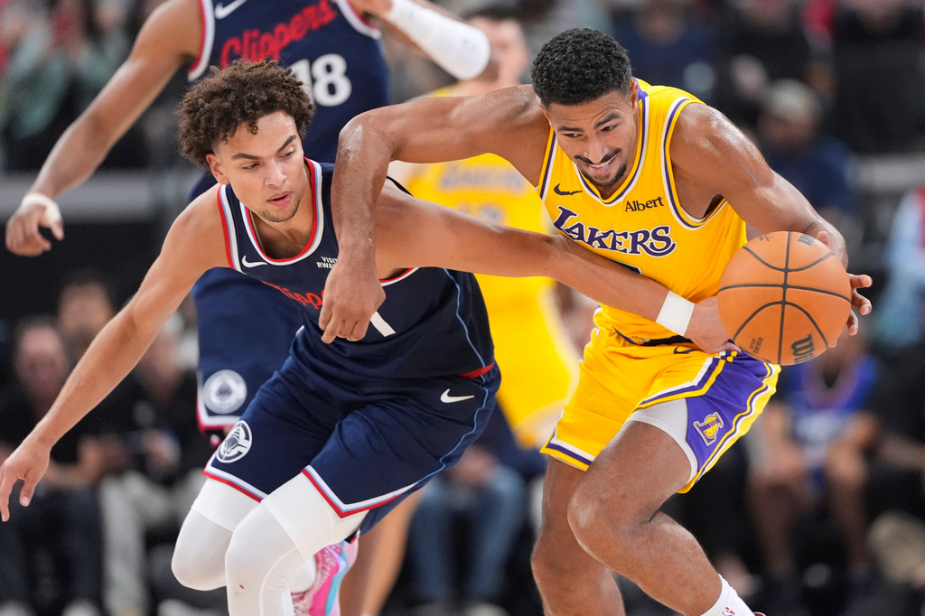 Los Angeles Clippers guard Keaton Wagler, left, and Los Angeles Lakers guard Quentin Grimes go after a loose ball during the first half of an NBA basketball game Wednesday, Oct. 28, 2026, in Inglewood, Calif. (AP Photo/Mark J. Terrill)