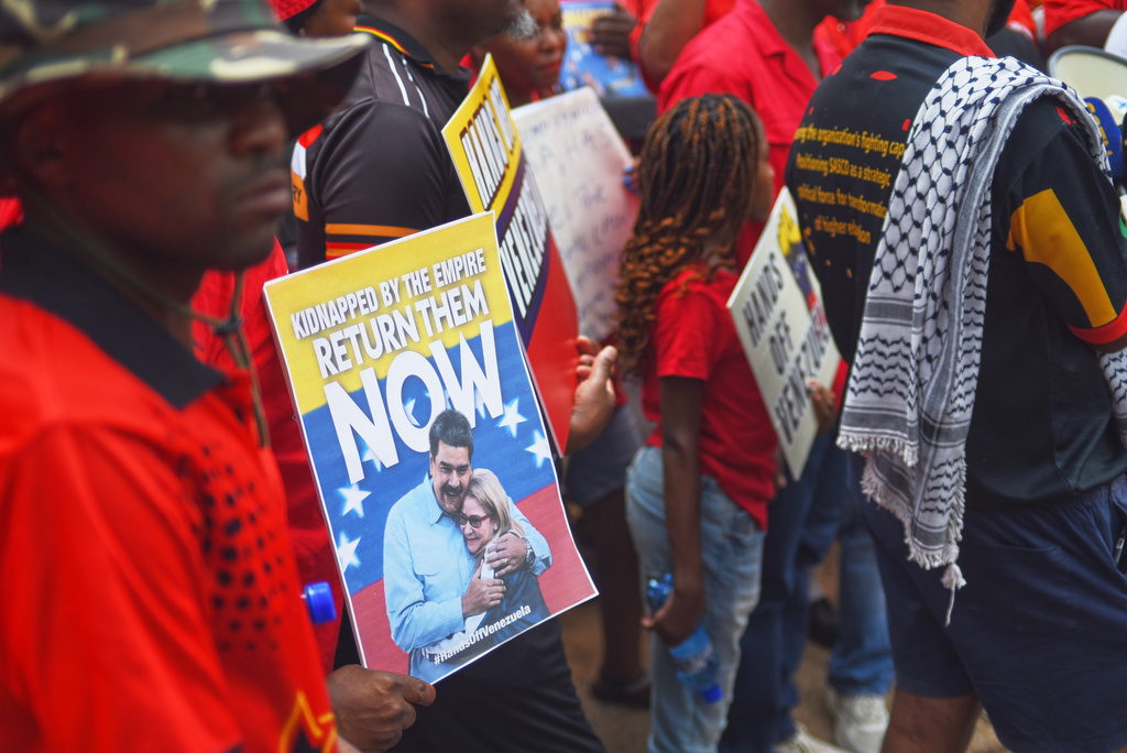 A man holds a placard featuring the Venezuelan President Nicolas Maduro and his wife during a demonstration outside the U.S. Embassy in Pretoria, South Africa, Thursday, Jan. 8, 2026. (AP Photo/Alfonso Nqunjana)