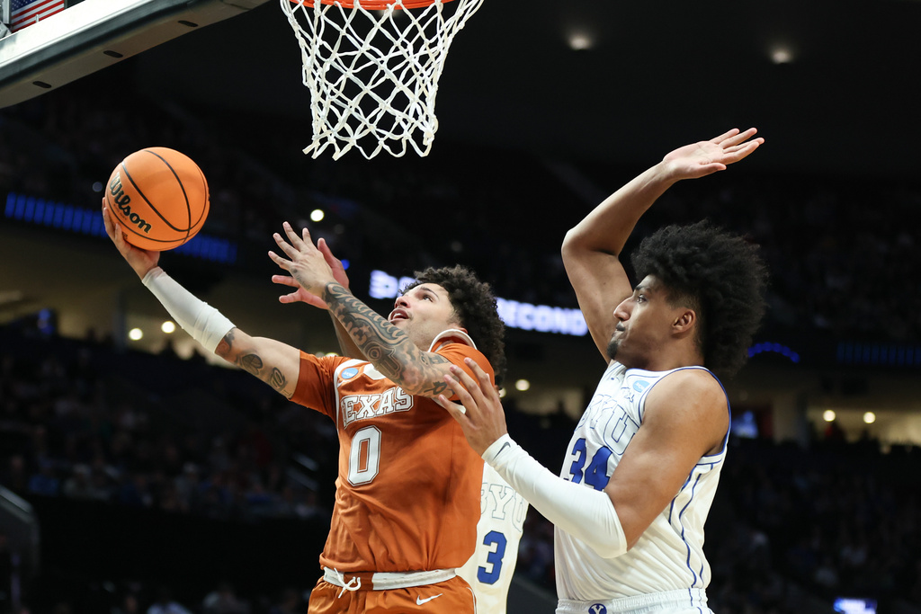 Texas guard Jordan Pope (0) shoots during the first half in the first round of the NCAA college basketball tournament against BYU, Thursday, March 19, 2026, in Portland, Ore. (AP Photo/Amanda Loman)