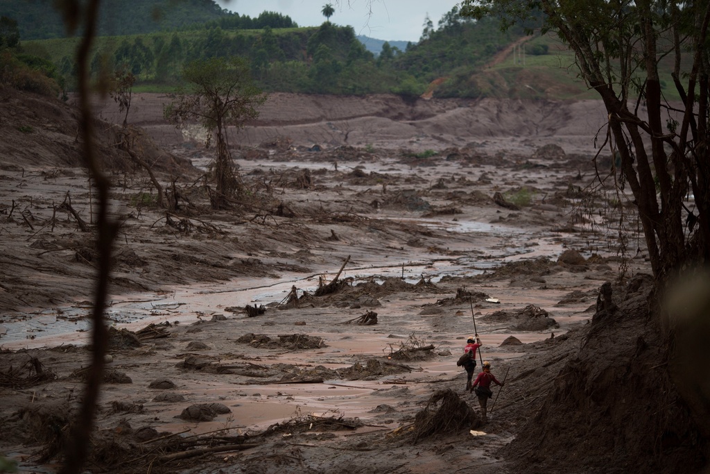 FILE - Rescue workers search for victims in Bento Rodrigues, Brazil, days after a dam burst on Nov. 8, 2015. (AP Photo/Felipe Dana, File)
