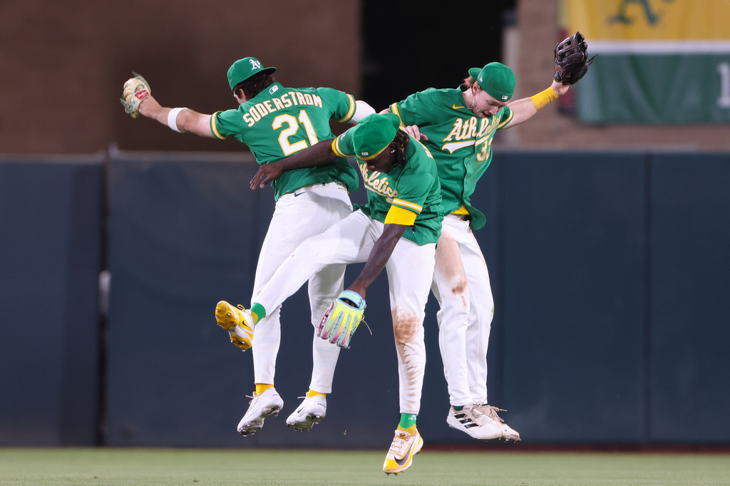 Athletics' Tyler Soderstrom (21), Lawrence Butler, center, and Henry Bolte celebrate the Athletics win over the Boston Red Sox in a baseball game Tuesday, July 28, 2026, in West Sacramento, Calif. (AP Photo/Scott Marshall)