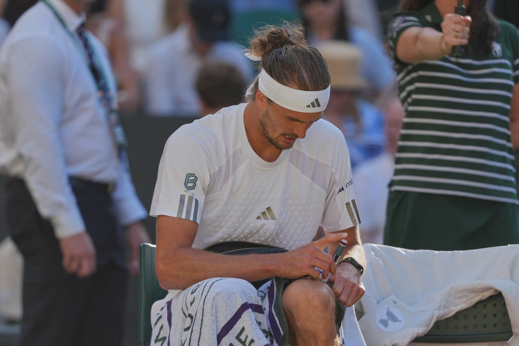 Alexander Zverev of Germany injects himself with insulin during a changeover in the men's singles final match against Jannik Sinner of Italy, at Wimbledon Tennis Championships in London, Sunday, July 12, 2026. (AP Photo/Kin Cheung)