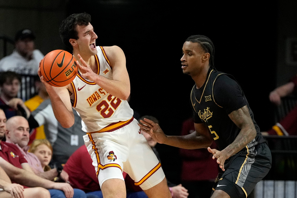Iowa State forward Milan Momcilovic (22) looks to pass around Central Florida guard Kris Parker (5) during the first half of an NCAA college basketball game, Tuesday, Jan. 20, 2026, in Ames, Iowa. (AP Photo/Charlie Neibergall)