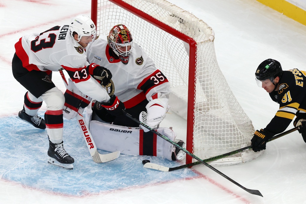 Boston Bruins' Michael Eyssimont (81) tries to get a shot past Ottawa Senators' Linus Ullmark (35) and Tyler Kleven (43) during the first period of an NHL hockey game, Thursday, Nov. 6, 2025, in Boston. (AP Photo/Michael Dwyer)