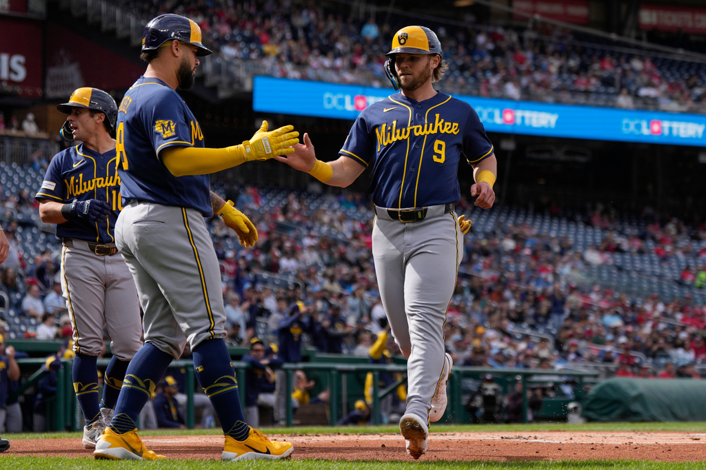 Milwaukee Brewers' Gary Sánchez, left, celebrates with Jake Bauers (9) after they scored on a single hit by Brandon Lockridge during the first inning of a baseball game against the Washington Nationals, Saturday, May 2, 2026, in Washington. (AP Photo/Jess Rapfogel)