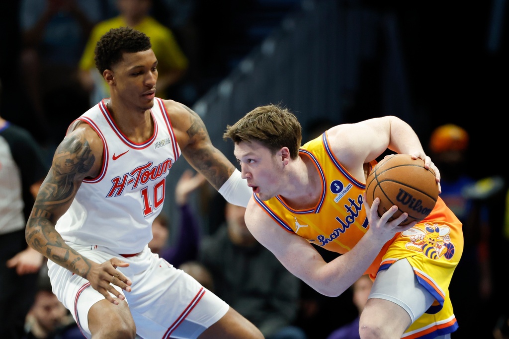 Charlotte Hornets guard Kon Knueppel, right, looks to drive against Houston Rockets forward Jabari Smith Jr. (10) during the first half of an NBA basketball game in Charlotte, N.C., Thursday, Feb. 19, 2026. (AP Photo/Nell Redmond)