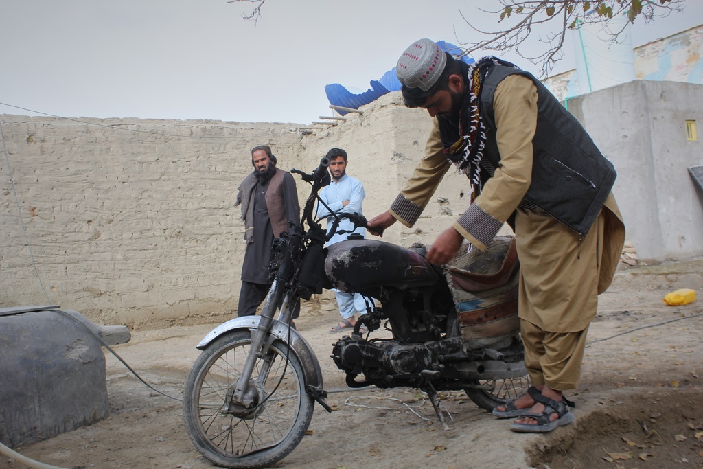 A man inspects a motorcycle damaged during an overnight exchange of fire between Afghan and Pakistani forces along the border in Spin Boldak, Kandahar province, Afghanistan, Saturday, Dec. 6, 2025. (AP Photo/Sibghatullah)