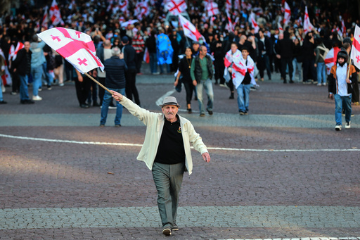Opposition supporters with Georgian national flags gather in the city center of Tbilisi, Georgia, on Saturday, Oct. 4, 2025, boycotting the municipal elections and call for the release of political opponents. (AP Photo/Zurab Tsertsvadze) Opposition supporters with Georgian national flags gather in the city center of Tbilisi, Georgia, on Saturday, Oct. 4, 2025, boycotting the municipal elections and call for the release of political opponents. (AP Photo/Zurab Tsertsvadze)