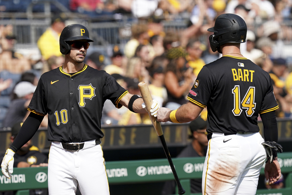 Pittsburgh Pirates' Joey Bart, right, is greeted by Bryan Reynolds, left, after scoring during the fourth inning of a baseball game against the Athletics, Sunday, Sept. 21, 2025, in Pittsburgh. (AP Photo/Matt Freed)