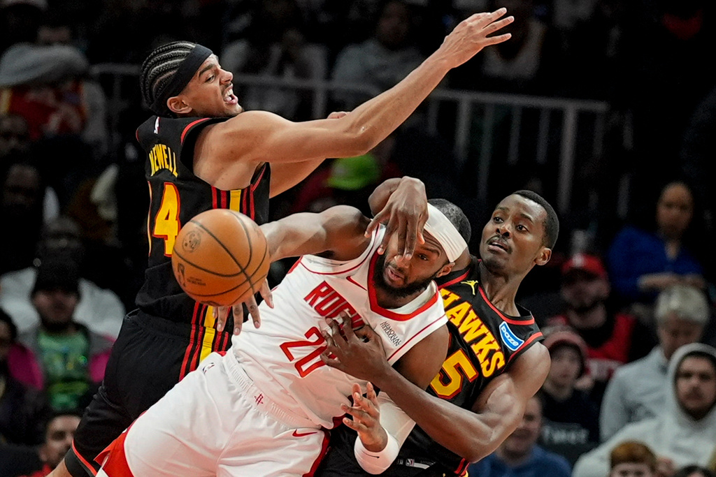 Houston Rockets guard Josh Okogie (20) moves the ball against Atlanta Hawks forward Asa Newell (14) during the first half of an NBA basketball game, Thursday, Jan. 29, 2026, in Atlanta. (AP Photo/Mike Stewart)