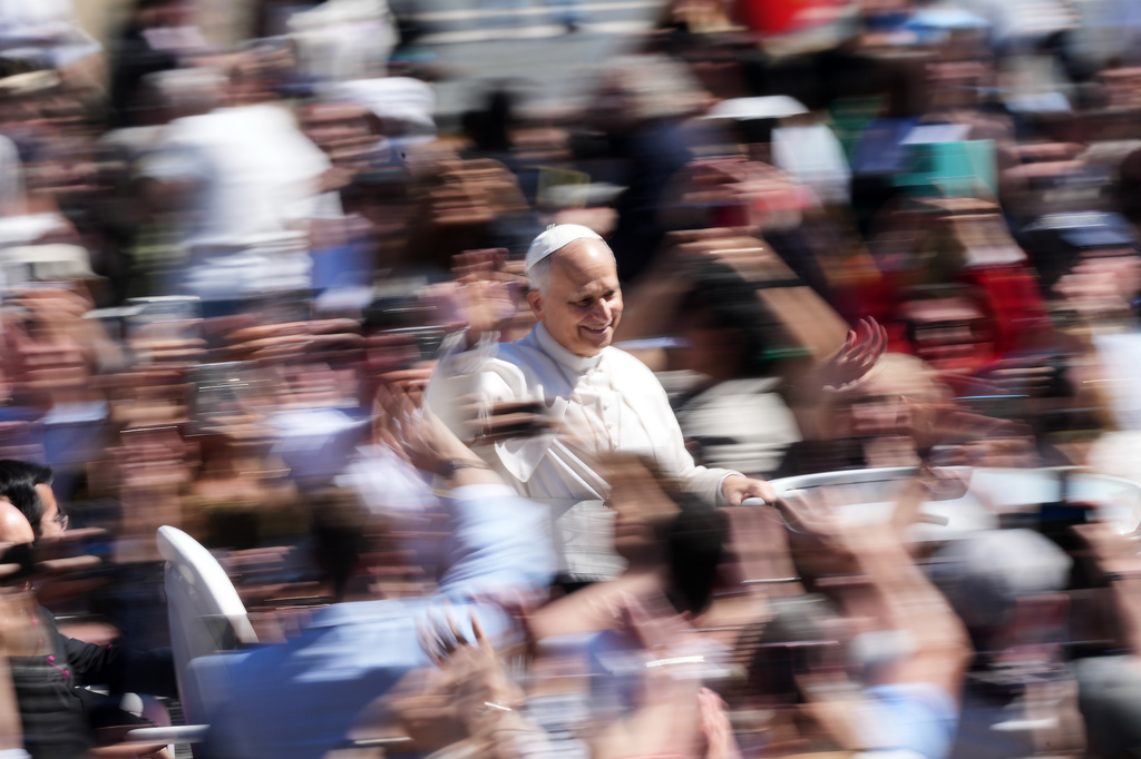 Pope Leo XIV greets the faithful at the end of Easter Mass he presided over in St. Peter's Square at the Vatican, Sunday, April 5, 2026. (AP Photo/Andrew Medichini)