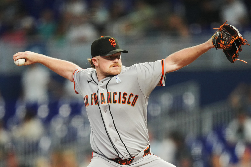 San Francisco Giants pitcher Logan Webb throws against the Miami Marlins during the first inning of a baseball game, Sunday, June 21, 2026, in Miami. (AP Photo/Jim Rassol)