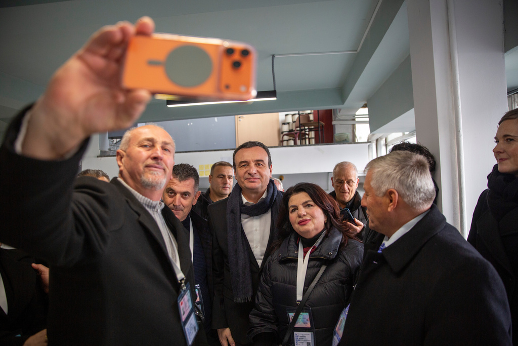 People take a photo with Kosovo's acting prime minister and leader of VeteVendosje political party Albin Kurti after voting in Kosovo's capital Pristina, Sunday Dec. 28, 2025. (AP Photo/Visar Kryeziu)