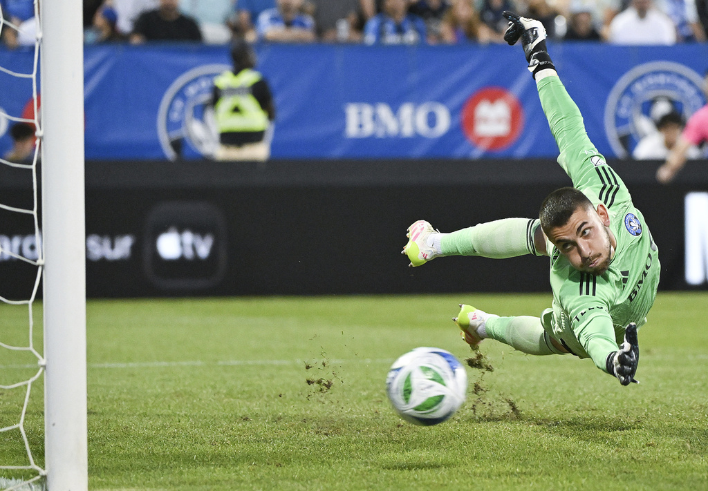CF Montreal goalkeeper Thomas Gillier is scored against by D.C. United's Jackson Hopkins during first-half MLS soccer match action in Montreal, Saturday, Aug. 16, 2025. (Graham Hughes/The Canadian Press via AP)