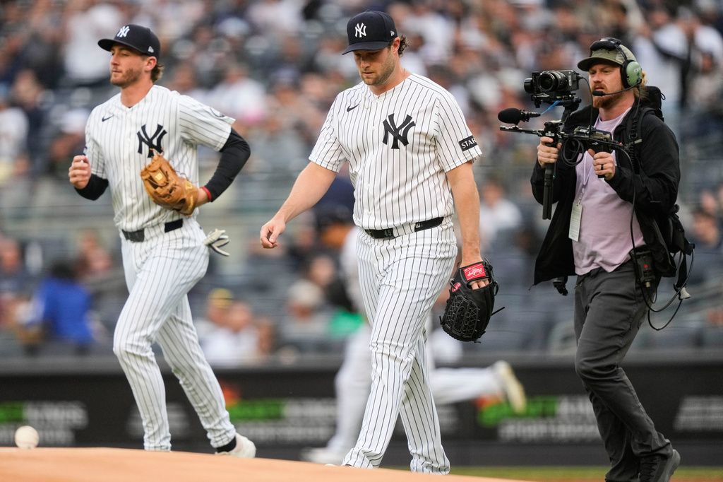 New York Yankees pitcher Gerrit Cole, center, walks to the mound before a baseball game against the Tampa Bay Rays, Friday, May 22, 2026, in New York. (AP Photo/Yuki Iwamura)