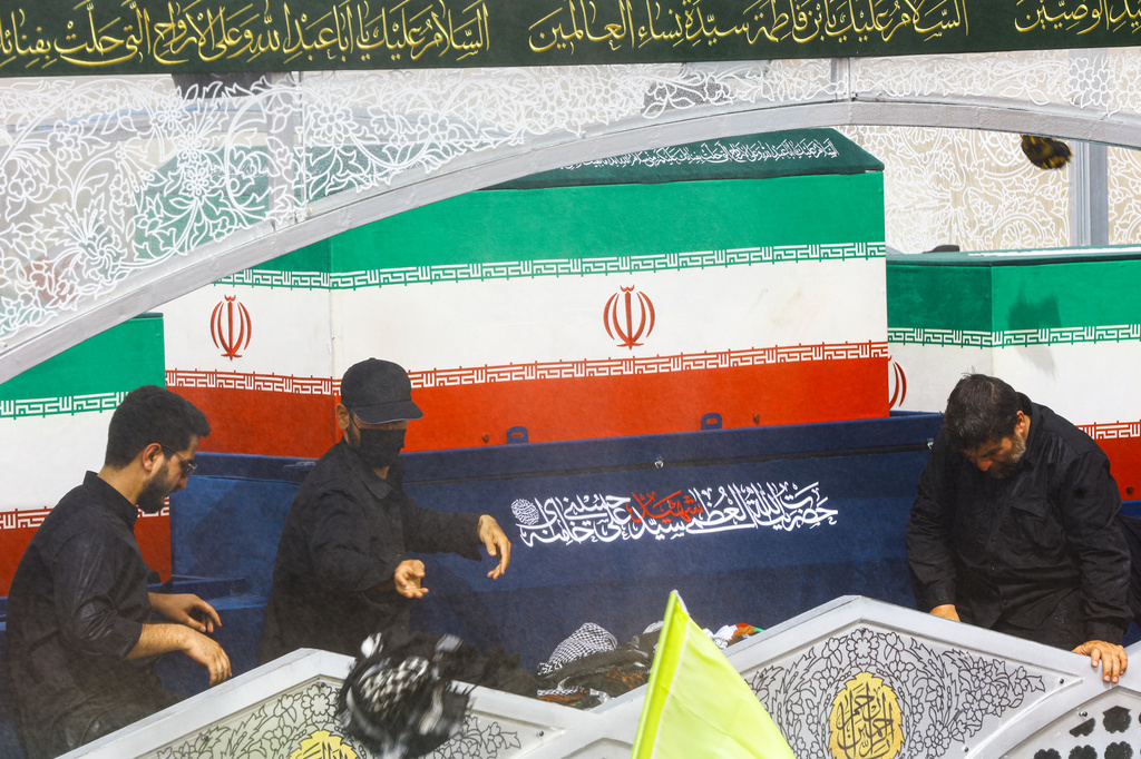 A truck carrying the coffins of the late Iranian Supreme Leader Ayatollah Ali Khamenei and members of his family makes its way through mourners during the funeral procession in Qom, the heart of religious studies in Iran, Tuesday July 7, 2026. (Mehdi Khezrian/ISNA via AP)