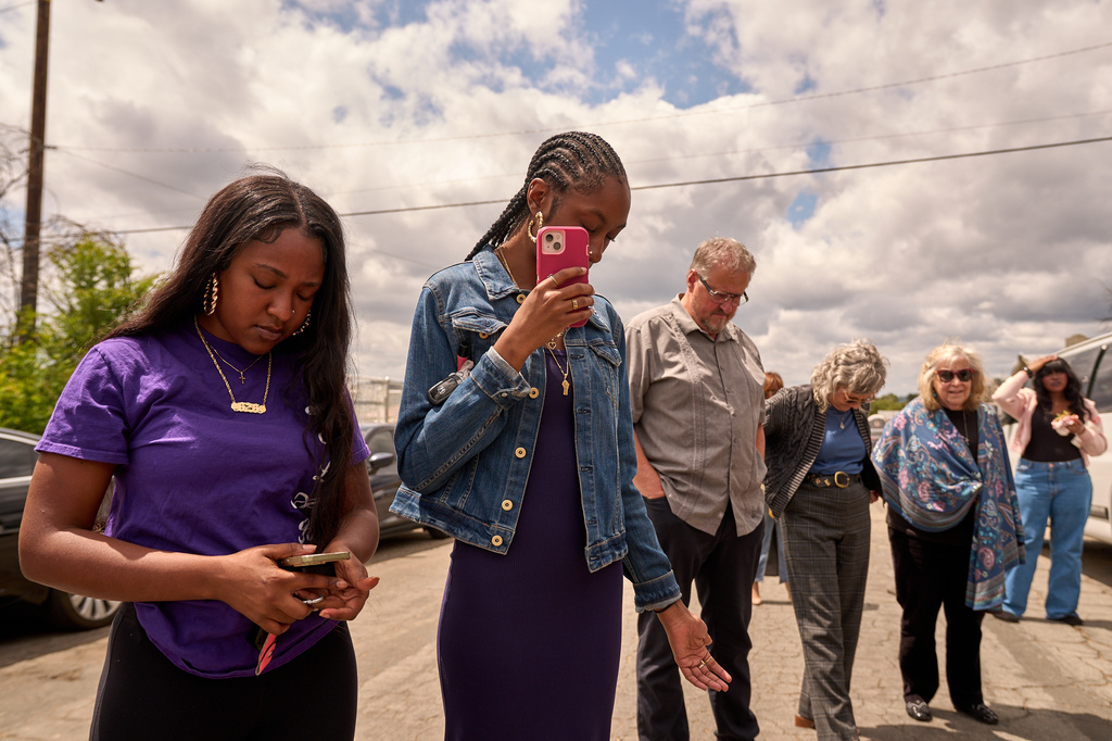 Members of the congregation join in prayer during the groundbreaking ceremony at the site of the burned Fountain of Life Nazarene Church, marking the beginning of its rebuilding, April 26, 2026, in Altadena, Calif. (AP Photo/Damian Dovarganes)