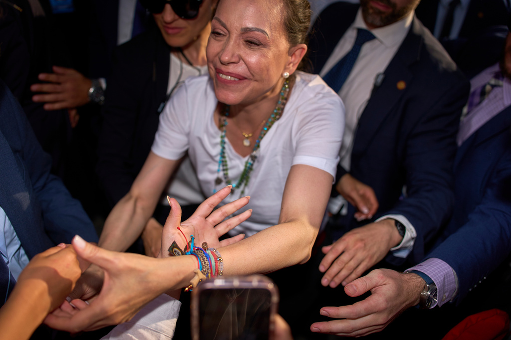 Venezuela's opposition leader Maria Corina Machado greets the crowd at Madrid's Puerta del Sol, in Madrid, Spain, Saturday, April 18, 2026. (AP Photo/Manu Fernandez)
