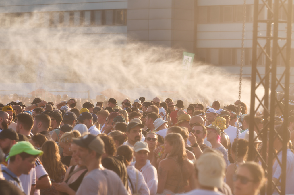 Thousands of fans are celebrating at a concert by techno star Paul Kalkbrenner on the Heiligengeistfeld while a water cannon is in operation on Saturday, June 27, 2026 in Hamburg, Germany. (Marcus Golejewski/dpa via AP)
