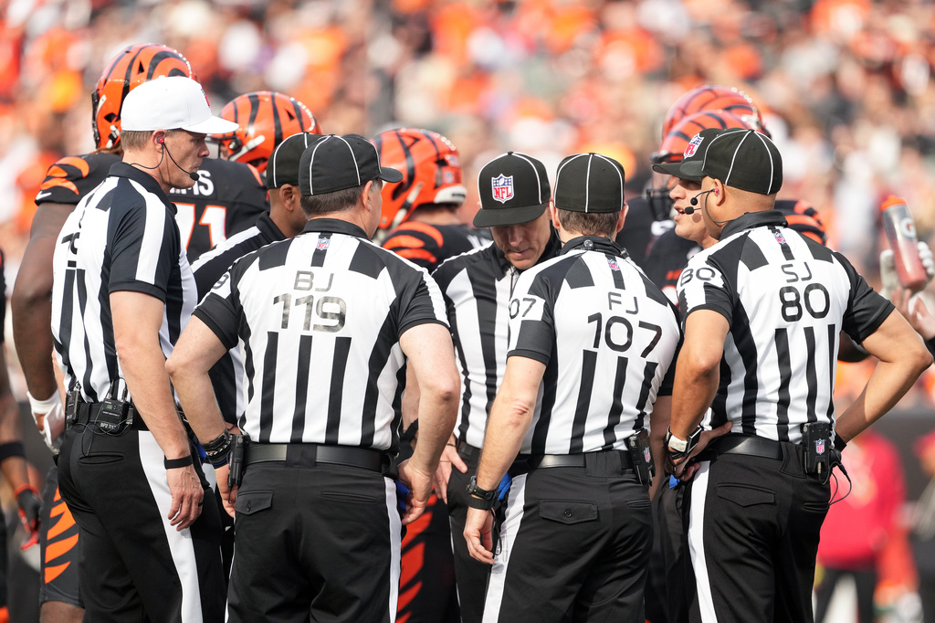 FILE - Referee Clay Martin (19), far left, talks with the officiating crew during an NFL football game between the Arizona Cardinals and the Cincinnati Bengals, Sunday, Dec. 28, 2025, in Cincinnati. (AP Photo/Kareem Elgazzar, file)
