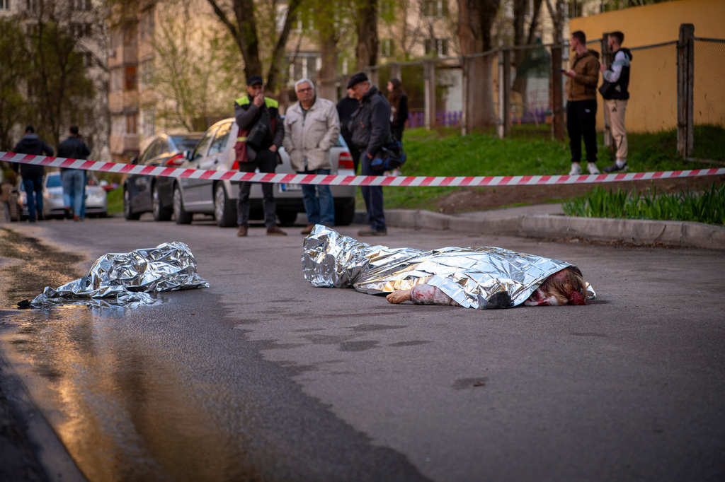 Bodies of victims are seen at the site where a gunman killed at least six people in the streets before being shot dead by police, in Kyiv, Ukraine, Saturday, April 18, 2026. (AP Photo/Dan Bashakov)