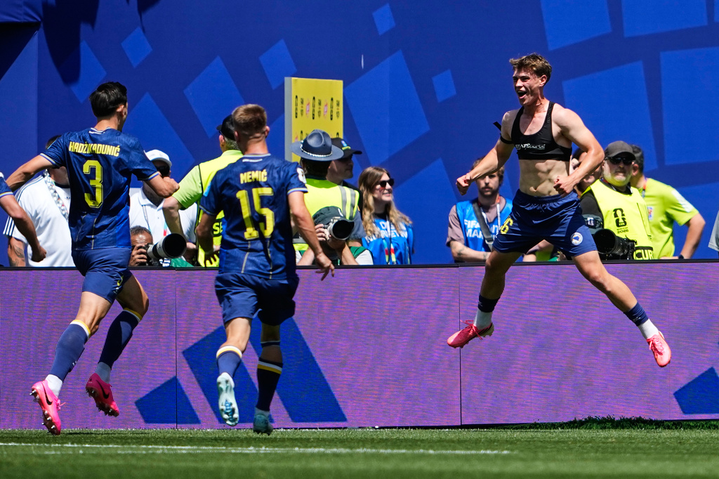 Bosnia's Ermin Mahmic, right, jumps as he celebrates with teammates after scoring his side's third goal during the World Cup Group B soccer match against Qatar in Seattle, Wednesday, June 24, 2026. (AP Photo/Lindsey Wasson)