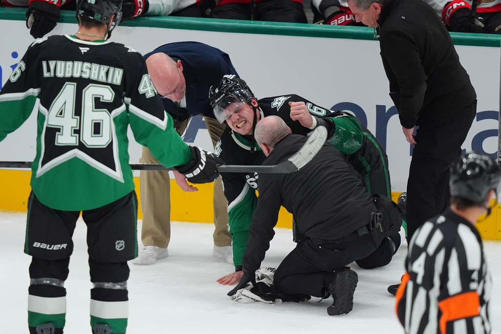 Dallas Stars defenseman Lian Bichsel (6) is helped after an injury during the second period of an NHL hockey game against the Ottawa Senators, Sunday, Nov. 30, 2025, in Dallas. (AP Photo/LM Otero)