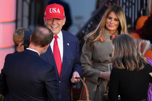 President Donald Trump, center left, and first lady Melania Trump, center right, greet families and hand out candy during a Halloween event on the South Lawn of the White House, Thursday, Oct. 30, 2025, in Washington. (AP Photo/Jacquelyn Martin) President Donald Trump, center left, and first lady Melania Trump, center right, greet families and hand out candy during a Halloween event on the South Lawn of the White House, Thursday, Oct. 30, 2025, in Washington. (AP Photo/Jacquelyn Martin)