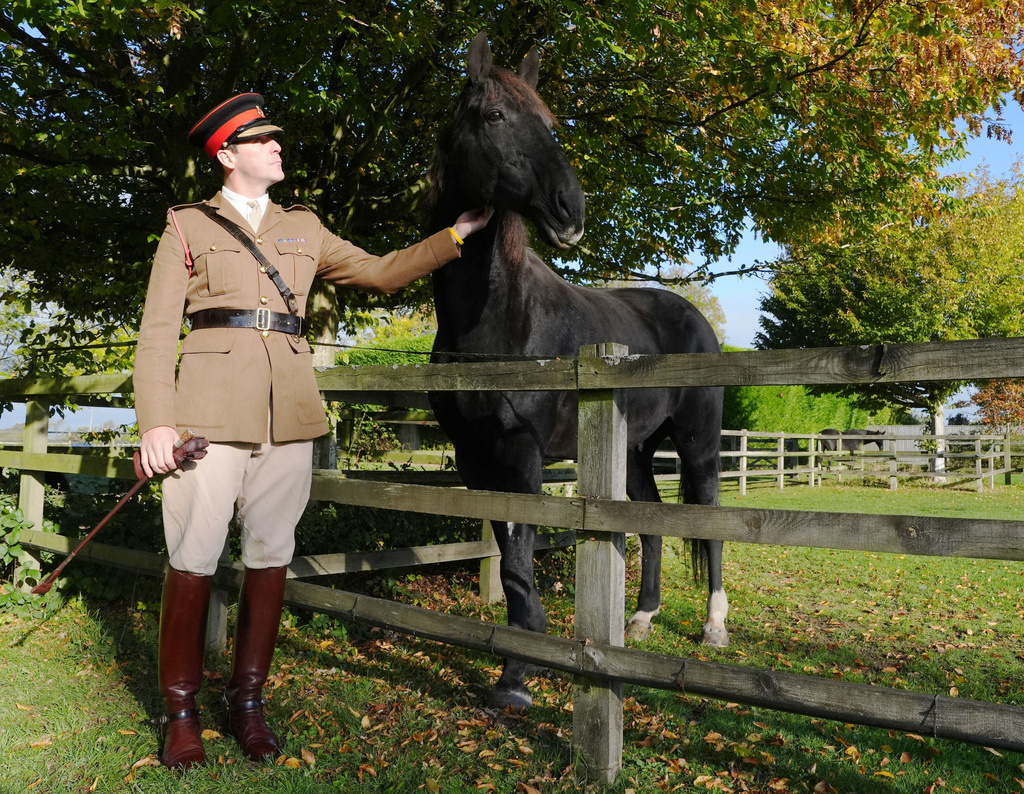 Life Guard Squadron Leader Major Tom Stewart says goodbye to Household Cavalry horse Quaker as he begins his retirement at The Horse Trust sanctuary, Thursday , Oct. 9, 2025, in Princes Risborough, Buckinghamshire, England. (Jonathan Brady/PA via AP)