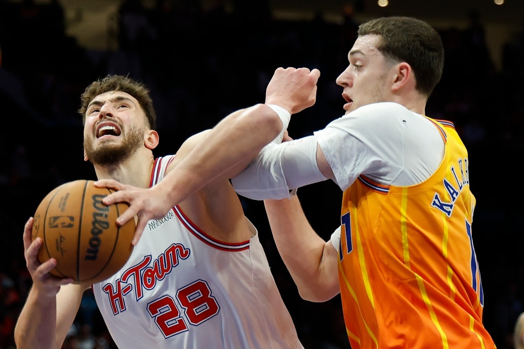 Houston Rockets center Alperen Sengun (28) looks to shoot against Charlotte Hornets center Ryan Kalkbrenner, right, during the first half of an NBA basketball game in Charlotte, N.C., Thursday, Feb. 19, 2026. (AP Photo/Nell Redmond)
