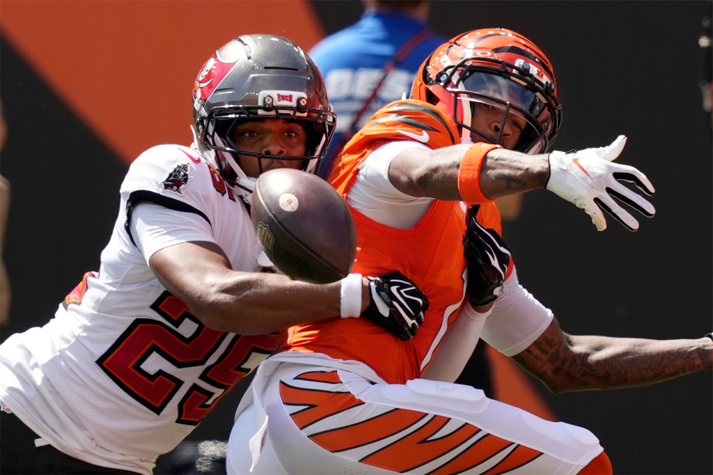 Cincinnati Bengals wide receiver Ja'marr Chase, right, can't hang onto a pass as he is defended by Tampa Bay Buccaneers cornerback Jacob Parrish (25) in the first half of an NFL football game Sunday, Sept. 13, 2026, in Cincinnati. (AP Photo/Carolyn Kaster)