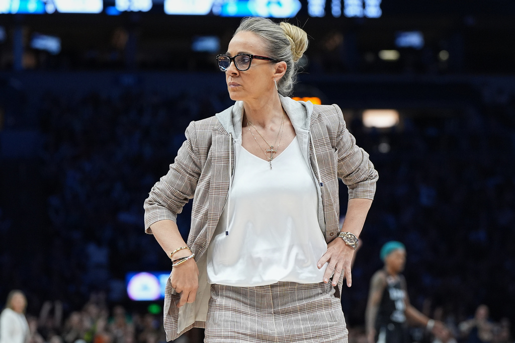 Las Vegas Aces head coach Becky Hammon stands on the court during a timeout in the first half of a WNBA basketball game against the Minnesota Lynx Saturday, Aug. 8, 2026, in Minneapolis. (AP Photo/Abbie Parr)