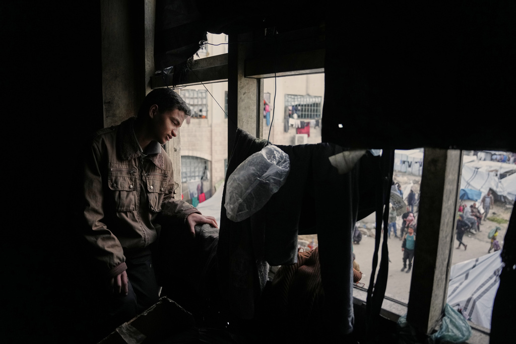 Mahmoud Abu Ishaq, 14, who is suffering vision loss and is awaiting permission to travel outside the Gaza Strip for medical treatment, poses for a photo in Khan Younis, Gaza Strip, Tuesday, Jan. 27, 2026. (AP Photo/Abdel Kareem Hana)